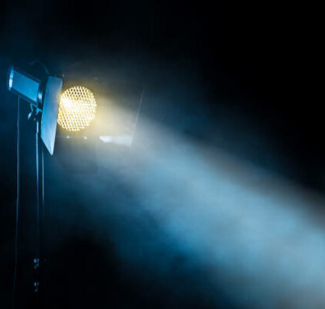 Theater spot light on black background with smoke